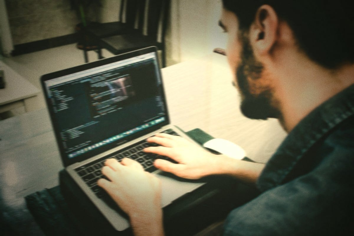 Code Metal coding on a laptop